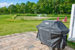 Weber Gas Grill Sits on Your Patio that Overlooks a Scenic View of Pond and Fountain and Trees